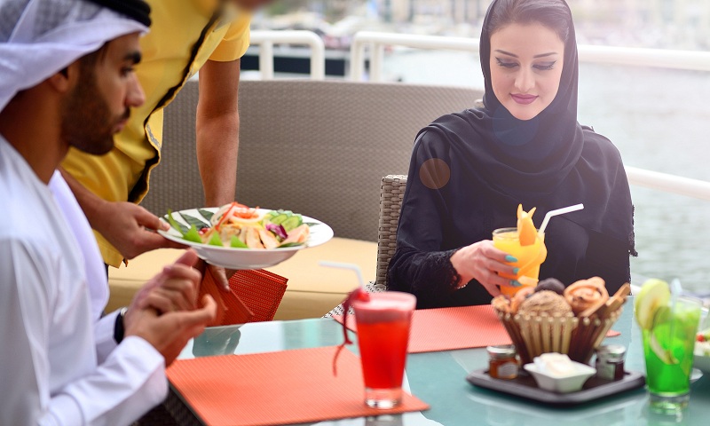 Young Emirati arab couple dining